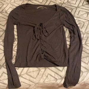 A long sleeve crossed gray tight shirt.